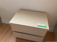 Side and top perspective highlighting the overall shape and finish of the bedside table.