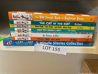 Stack of 7 Dr. Seuss children's books showing titles and colorful spines on a shelf.