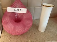 Photo of two vases on kitchen counter, pink art glass vase with ruffled top and white ceramic vase with gold rim