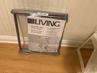 Photo of the unopened For Living accordion-style clothes dryer, showing the packaging and folded rack.