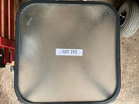 Top view of the small garden table showing the textured glass surface and black frame with 'LOT 255' label.