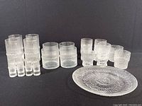 Full lot showing six tall glasses, three small glasses, four wide lowball glasses, and one plate.