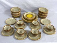 Full set of Mikasa Natures Song dishware displayed on a white surface showing grouping of all plates, bowls, cups, and saucers.