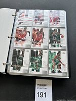 Photo of a binder page featuring basketball cards with players in Chicago Bulls and Boston Celtics jerseys numbered 1/6 with CI Prove series markings.