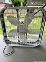 Front view of the white Holmes box fan showing its five blades and protective metal grille.