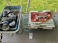 Photo of a metal wired folding rack with Sterno packaging and aluminum foil tray with Sterno fuel cans.