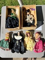 Full lot of 6 vintage dolls showing in two cardboard boxes and on table