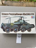 Box cover of the Schwerer Panzerspähwagen 8Rad Sdkfz232 military model kit by Tamiya showing the armored vehicle and commander figure illustration.