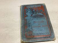 Front cover showing title, series, author, and decorative floral illustration with some pencil markings and wear.