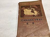 Cover of the booklet showing the title 'Canada 1936: The Official Handbook of Present Conditions and Recent Progress' with a map illustration in brown and tan.