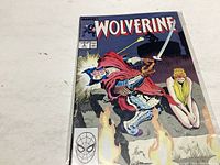 Photo of the Wolverine comic book issue #3 showing front cover art with Wolverine in armor and a woman in the background.