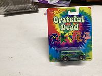 Photo of unopened Hot Wheels Grateful Dead Dream Panel pack showing die-cast toy van and colorful tie-dye card