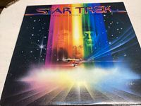 Front cover of the Star Trek The Motion Picture original soundtrack vinyl record showing colorful artwork with starship and main character faces.