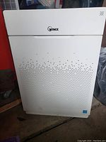 Front view of the Winix HR900 air purifier showing overall condition and perforated grille.