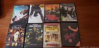 Photo of 8 DVDs including '10,000 BC', 'Ninja Assassin', 'The Last Ride', 'Setup', 'The Order', 'Jack Reacher', 'Primal Fear', 'Porky's'.