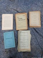 Top view of five naturalist-related publications, including The Ottawa Naturalist and Field-Naturalists' Club booklets, arranged on a stone surface.