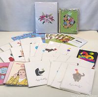 Overview of laid out greeting cards with various birthday and floral designs