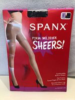 Front of the box showing Spanx branding, product name, photo of legs wearing pantyhose, key features and denier information.