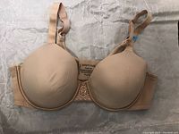 Light beige Vanity Fair bra, size 38C, showing front view with molded cups and adjustable straps.