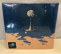 Front cover of the sealed vinyl record showing the iconic splash artwork with the band's logo and album title 'Time'.