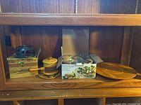 Full lot on display shelf showing fondue set, mixing bowls box, and Lazy Susan plate