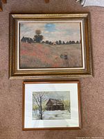 Both framed artworks placed side by side on carpet floor showing overall condition and size difference.