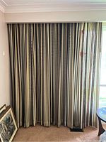 Full view of Mid-Century Modern style heavy drapes closed over window, adjacent to a sheer curtain.