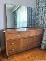 Front view of the Mid-Century Modern six-drawer dresser with mirror positioned on top, showing drawer handles and wood finish.