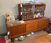 Front view of upper and lower teak hutch with contents