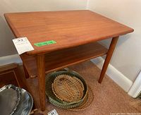 Front-left angle showing tabletop, lower shelf, and tapered legs.