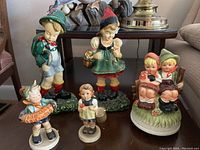 View of all four figurines and music box showing condition and size