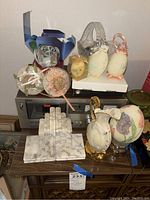 Overview photo of marble bookends, decorative eggs and Akai stereo cassette deck on wooden table