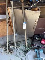 Lot showing Makita drill, two manual pipe benders, garden hose, metal panel