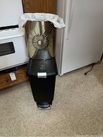 Front and side views of stacked metal and plastic trash cans showing pedal lid and plastic liners.