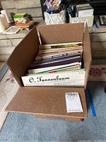 Box of vintage vinyl LP records seen upright with album covers visible through the top.