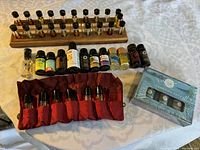 Overview of all essential oil bottles including wooden rack, small bottles, rollerballs, and packaged set.