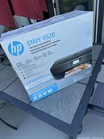 Photo of the unopened HP Envy 4520 printer box showing the product image and model number.