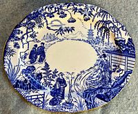 Top-down view of the oval platter showing detailed blue and white Mikado pattern with scenes of people, pagodas, foliage and oriental elements.