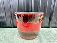 Front view of vintage West Germany planter showing red and dark brown glaze bands.