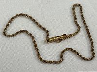 Overall view of the 10k gold twisted rope chain ankle bracelet showing clasp and chain detail