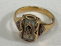 Top and front view of the Live Oak High School 10k gold class ring showing black enamel face with LO, Live Oak HS, and gold raised details.