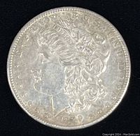 Obverse side of the 1889 Morgan Silver Dollar featuring Lady Liberty profile and date.