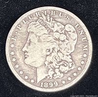 Front (obverse) of 1899-O Morgan Silver Dollar showing Lady Liberty profile with date 1899.