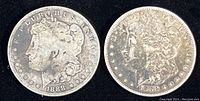 Obverse side showing profile of Liberty and date 1888 on two Morgan Silver Dollars; left coin heavily worn, right coin better detail.