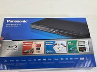 Packaged Panasonic box displaying product image and features such as online entertainment and smart home networking.