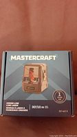 Mastercraft Cross-Line Laser Level box front with product image and specifications showing 30ft/10m range and 1-year warranty