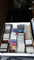 Photo showing a large box filled with multiple stacks of sports cards in various sections, organized and sorted.