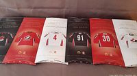 View of six sealed mini jerseys from 2008 Team Canada hockey players in their packaging.