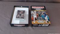 New sealed box of Monopoly Prizm NBA Trading Cards Set 4 showing front with NBA players and partially opened box with cards inside.