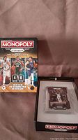 Photo of Monopoly Prizm NBA Trading Cards Set 6 box and opened package showing trading cards.
